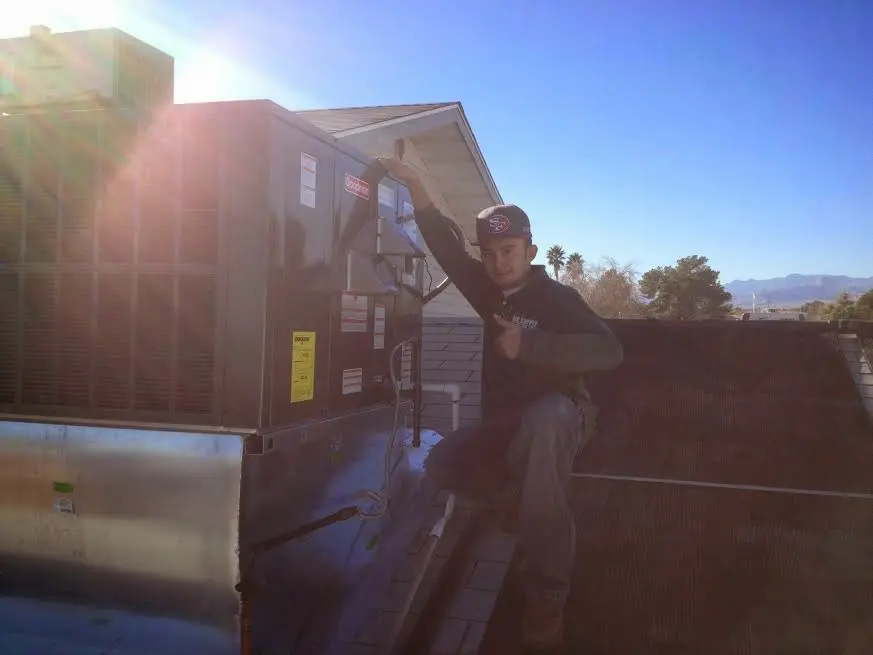 HVAC technician performing HVAC Inspection on a rooftop unit in Bethel Park